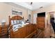 Relaxing main bedroom suite featuring a large bed, tray ceiling, and neutral color palette at 2300 Natoma Blvd, Mount Dora, FL 32757