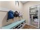 Mudroom featuring a cushioned bench, storage for shoes, and access to laundry room at 2300 Natoma Blvd, Mount Dora, FL 32757