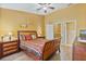 Comfortable bedroom with ceiling fan, wood-look floors, and ensuite bathroom at 2864 Polana St # 104, Orlando, FL 32835