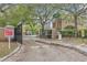 A gated entrance to the community with mature trees, landscaping and attractive signage at 2864 Polana St # 104, Orlando, FL 32835