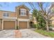 Charming townhome exterior with attached garage, well-manicured landscaping, and a welcoming entrance at 2864 Polana St # 104, Orlando, FL 32835