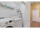 Efficient laundry room with washer, dryer, and storage shelves at 2864 Polana St # 104, Orlando, FL 32835