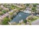 Scenic aerial view of a community pond with fountain, surrounded by lush landscaping and community buildings at 2864 Polana St # 104, Orlando, FL 32835