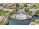 Stunning aerial view of a community pool with lounge chairs, covered cabanas, and lush landscaping at 2864 Polana St # 104, Orlando, FL 32835