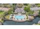 Stunning aerial view of a community pool with lounge chairs, covered cabanas, and lush landscaping at 2864 Polana St # 104, Orlando, FL 32835