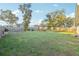 Expansive backyard features a well-maintained lawn, a wooden fence, and a charming gazebo creating a serene outdoor space at 3176 Sw 127Th St, Ocala, FL 34473