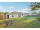 Large backyard with ample green space, a sliding glass door and a wood fence at 3176 Sw 127Th St, Ocala, FL 34473