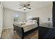 Comfortable bedroom featuring a queen-size bed with decorative pillows and a large window providing natural light at 3176 Sw 127Th St, Ocala, FL 34473