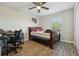 Cozy bedroom features a full-sized bed, ceiling fan, and a desk area near the window offering a functional space at 3176 Sw 127Th St, Ocala, FL 34473
