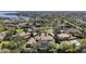 Expansive aerial view showcasing luxury home with mature landscaping, nearby lake and beautiful neighborhood at 3402 Cocard Ct, Windermere, FL 34786