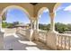 Private balcony with architectural columns, stone floors, and beautiful views of the manicured grounds at 3402 Cocard Ct, Windermere, FL 34786