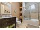 Bathroom with dark wood vanity, neutral walls, and a shower with glass enclosure at 3402 Cocard Ct, Windermere, FL 34786