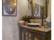 Charming bathroom vanity with granite countertop, ornate cabinet, and decorative floral artwork at 3402 Cocard Ct, Windermere, FL 34786