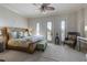 Bright bedroom with light walls, wicker furnishings, and French doors to a private balcony at 3402 Cocard Ct, Windermere, FL 34786