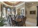 Formal dining room featuring a decorative ceiling, chandelier, and large windows at 3402 Cocard Ct, Windermere, FL 34786