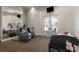 This exercise room includes fitness machines, a mirror wall, and French doors for a bright workout space at 3402 Cocard Ct, Windermere, FL 34786