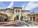 Elegant home featuring a prominent fountain, a grand entrance, and a circular brick driveway at 3402 Cocard Ct, Windermere, FL 34786