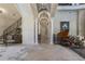 Grand foyer with soaring ceilings, ornate columns, wrought iron staircase, and piano at 3402 Cocard Ct, Windermere, FL 34786