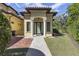 Elegant home exterior featuring a stone pathway leading to a column-lined front entrance at 3402 Cocard Ct, Windermere, FL 34786