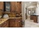 Hallway boasts detailed trim and elegant cabinetry with marble countertops and tile backsplash at 3402 Cocard Ct, Windermere, FL 34786