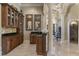 Hallway boasts detailed trim and elegant cabinetry with marble countertops and tile backsplash at 3402 Cocard Ct, Windermere, FL 34786