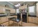 A spacious laundry room with modern appliances, custom cabinetry, and a functional island at 3402 Cocard Ct, Windermere, FL 34786