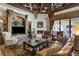 Elegant living room featuring a fireplace, ceiling fans, and a large built-in entertainment center at 3402 Cocard Ct, Windermere, FL 34786