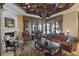 Bright living room with a coffered ceiling, fireplace, and view of the outdoor living space at 3402 Cocard Ct, Windermere, FL 34786