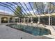 Stunning screened pool with pergola, columns, lounge chairs and well-maintained landscaping offers a private retreat at 3402 Cocard Ct, Windermere, FL 34786