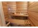 Inviting sauna with wooden benches, paneling, and essential accessories for a relaxing experience at 3402 Cocard Ct, Windermere, FL 34786