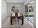 Bright dining room features a modern table with seating for six, a decorative rug, and lots of natural light at 3418 Douglas Fir Dr, Apopka, FL 32703