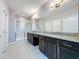 Bathroom featuring double sinks, dark cabinets, and a glass-enclosed shower at 434 Alcove Dr, Groveland, FL 34736