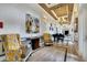 Bright hallway featuring patterned chairs, elegant lighting, art, and piano at 434 Alcove Dr, Groveland, FL 34736