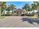 Community pool house surrounded by manicured landscaping and tall palm trees at 434 Alcove Dr, Groveland, FL 34736