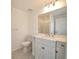 A bright bathroom featuring a single sink vanity and decorative tiled floors at 445 Live Oak Ave, Chuluota, FL 32766