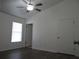 Bedroom with wood-look flooring, natural light and closet at 445 Live Oak Ave, Chuluota, FL 32766