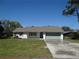 Charming single-story home with a well-manicured lawn and attached garage at 445 Live Oak Ave, Chuluota, FL 32766