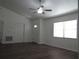 Bright living room with wood-look flooring, vaulted ceiling, and a ceiling fan at 445 Live Oak Ave, Chuluota, FL 32766