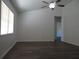 Living room with bright natural light, ceiling fan, and wood-look flooring at 445 Live Oak Ave, Chuluota, FL 32766