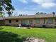 Back exterior shows a small yard, the back side of the home, an AC unit, and a sliding glass door at 4845 Elese St, Orlando, FL 32811