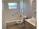 Standard bathroom featuring a tiled shower-tub combo, toilet, and sink with vanity at 4845 Elese St, Orlando, FL 32811