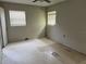 Bedroom featuring two windows, a ceiling fan, and damaged linoleum flooring at 4845 Elese St, Orlando, FL 32811