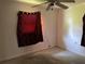 Bedroom featuring a ceiling fan, window with dark curtain, and a beige wall color at 4845 Elese St, Orlando, FL 32811