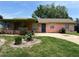 A well-lit, one-story home with a lush green lawn and a concrete driveway at 4845 Elese St, Orlando, FL 32811