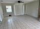 Spacious living room featuring tile floors and a sliding glass door for ample natural light at 4845 Elese St, Orlando, FL 32811