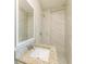 This bright bathroom features a modern vanity, granite countertop, a mirror, and a shower at 4906 Cortez Dr, Orlando, FL 32808