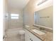 Bathroom featuring granite counters, tub with white marble-style tiling, and new fixtures at 4906 Cortez Dr, Orlando, FL 32808