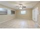 Neutral bedroom featuring tile floors, windows, and a ceiling fan at 4906 Cortez Dr, Orlando, FL 32808