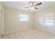 Bedroom featuring tile flooring, built-in shelving, ceiling fan, and natural light at 4906 Cortez Dr, Orlando, FL 32808