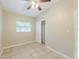 Bedroom featuring tile flooring, closet, ceiling fan, and window at 4906 Cortez Dr, Orlando, FL 32808